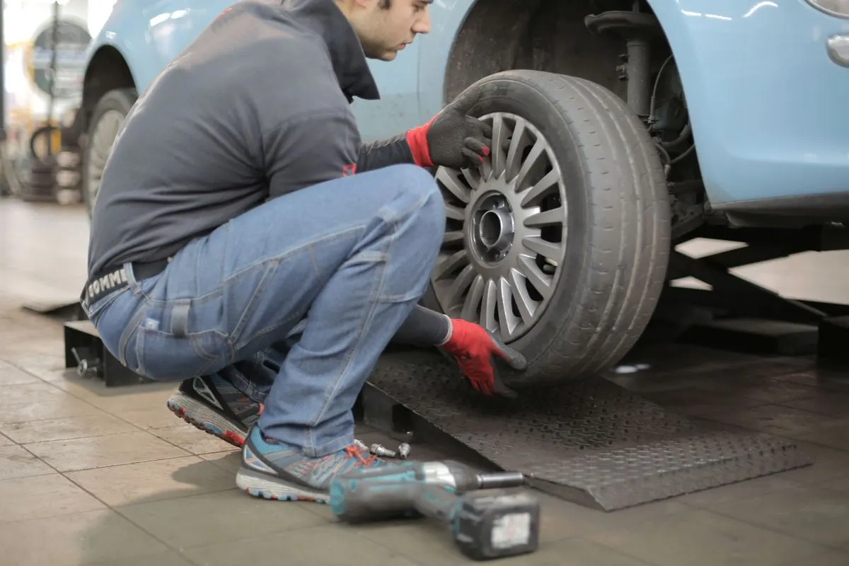 A mechanic checking a tyre