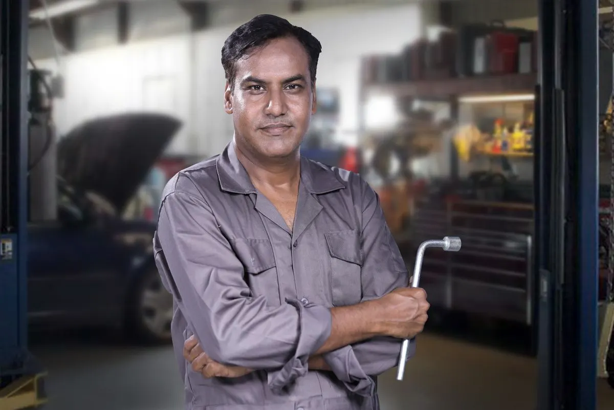 A mechanic holding a wrench