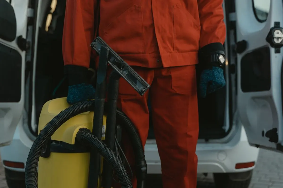 A cleaner loading equipment from a van