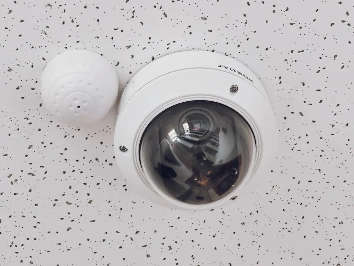 A dome camera on a ceiling