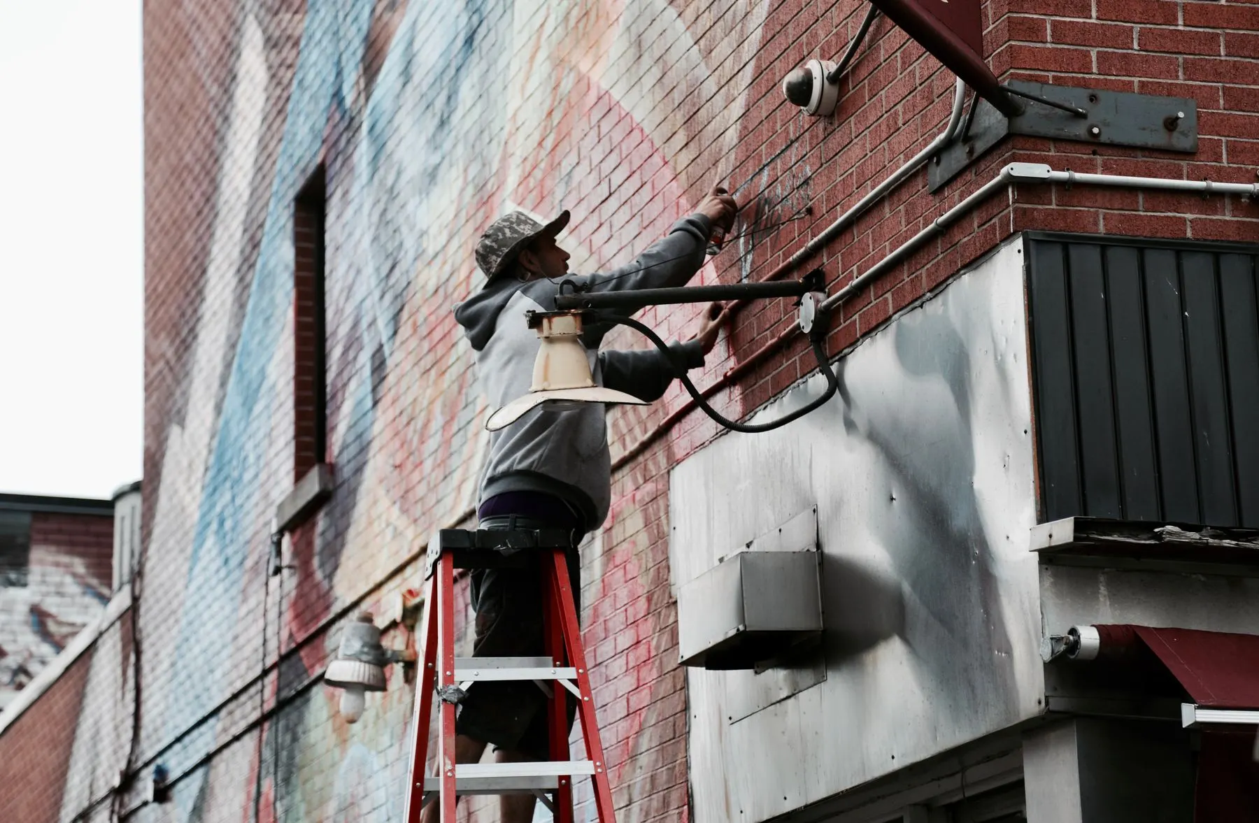 An installer fitting a camera to a wall