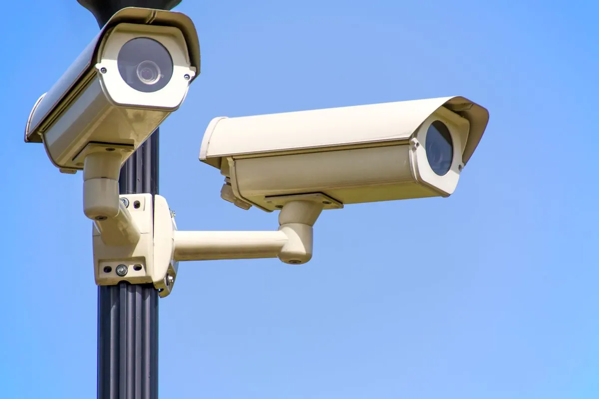Two security cameras on a pole
