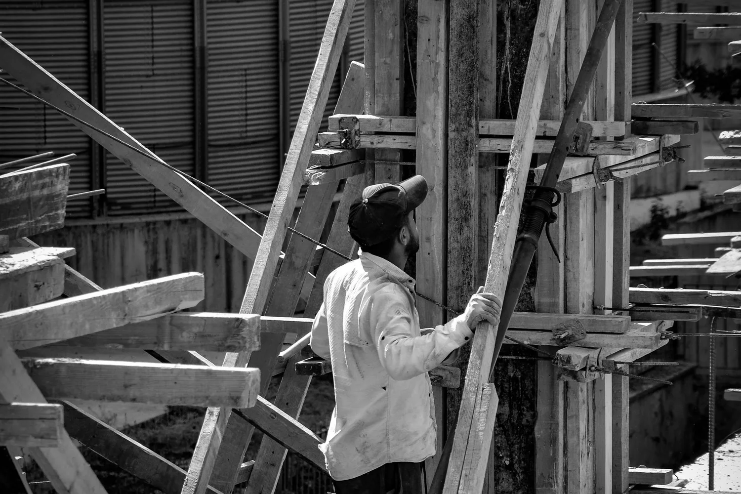 A construction worker handling formwork on a building site